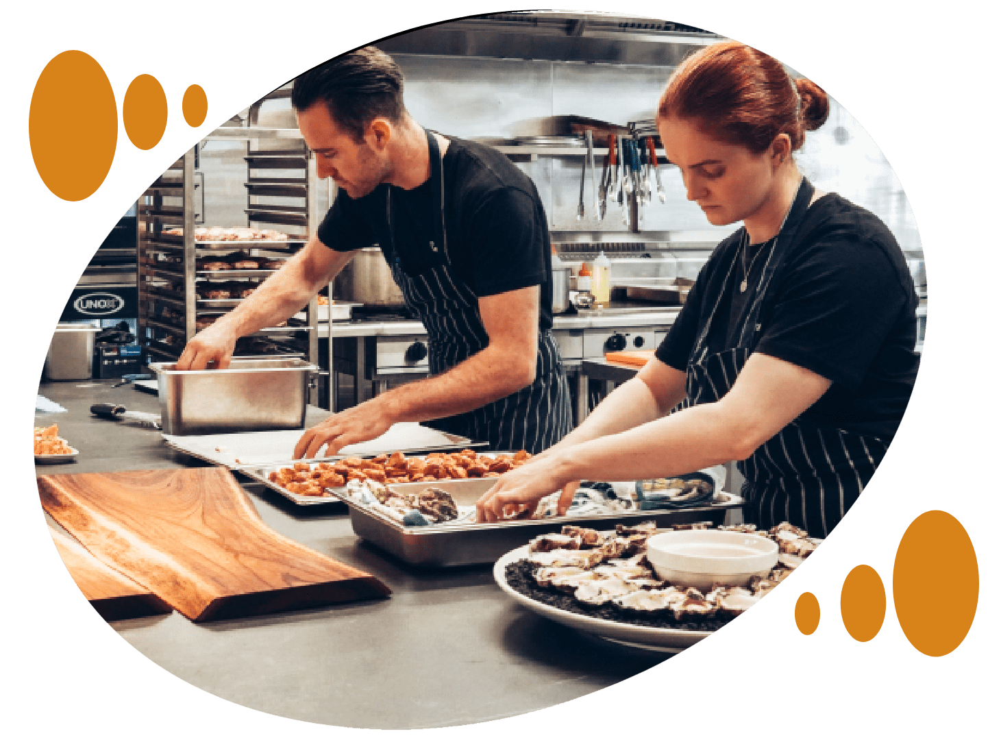 Two people preparing food in a kitchen.